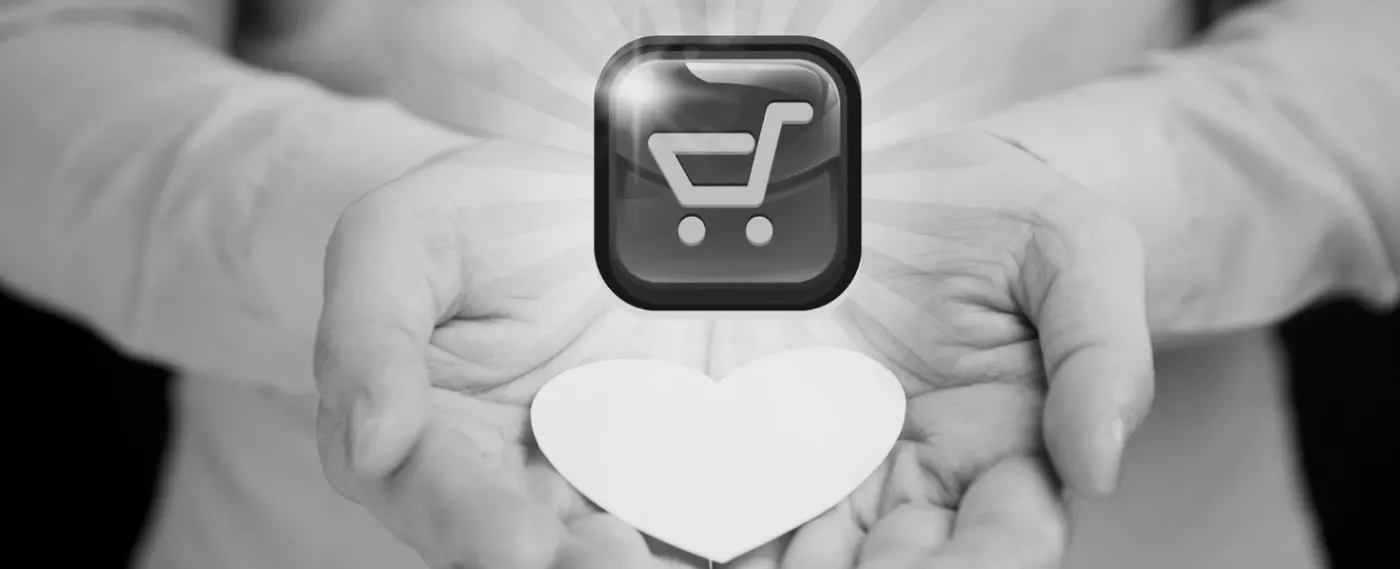 Mãos estendidas segurando um coração de papel, com o ícone de um carrinho de compras acima